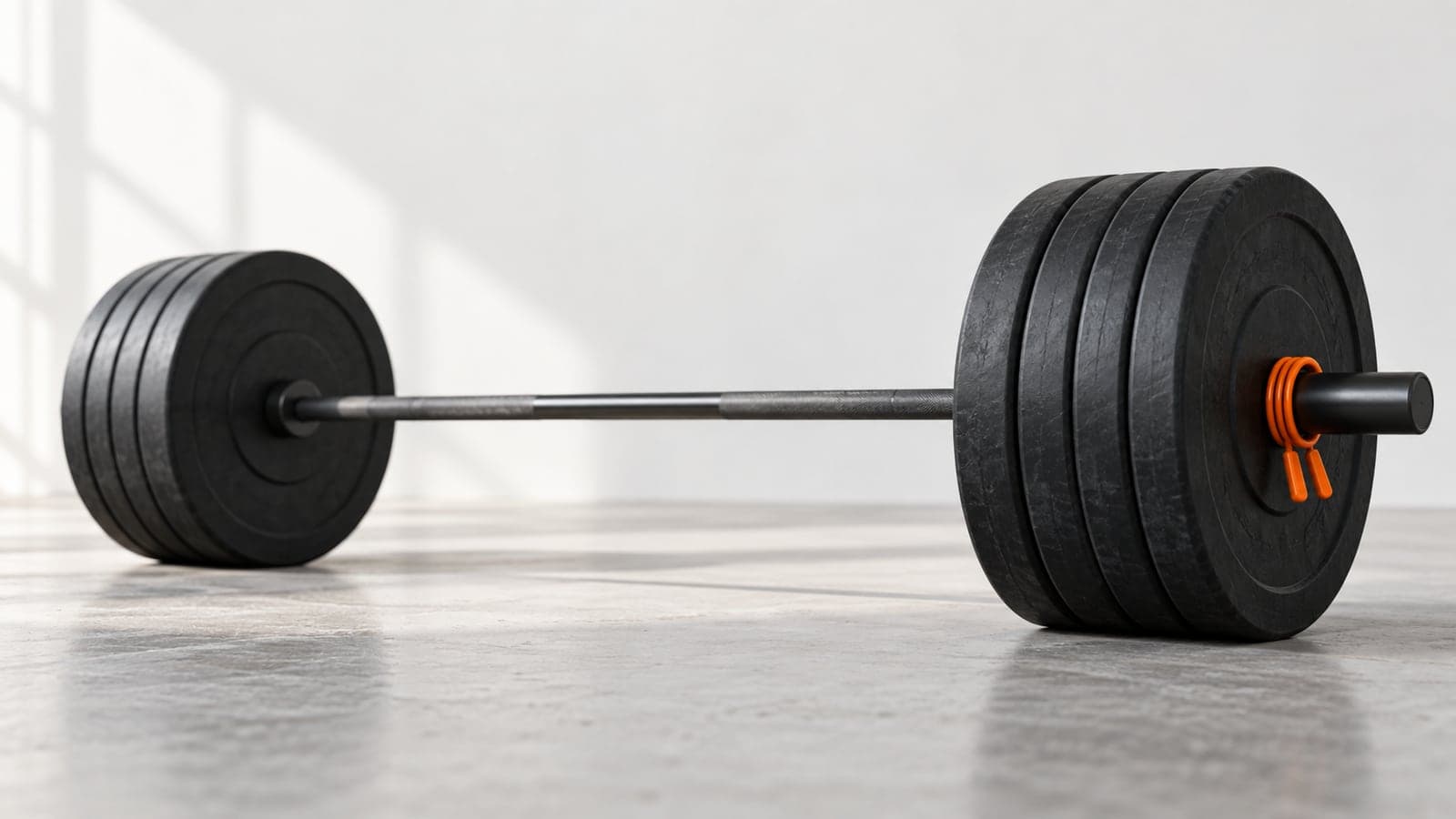 A loaded barbell resting on a gym floor